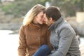 Adult couple in love flirting on the beach in winter Royalty Free Stock Photo