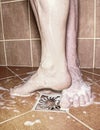 Couple playing in shower, feet on rural floor Royalty Free Stock Photo