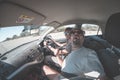 Adult couple selfie on road trip inside car, funny facial expression. Fisheye, people traveling and adventure, toned desaturated i Royalty Free Stock Photo