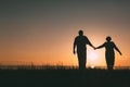 Adult couple silhouettes at sunset.