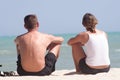 Adult couple sitting on the beach