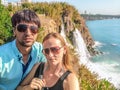 Adult couple taking a selfie in front of Lower Duden Waterfall in Antalya