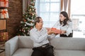 Adult daughter giving christmas gift to her father Royalty Free Stock Photo