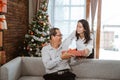 Adult daughter giving christmas gift to her father Royalty Free Stock Photo