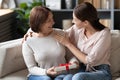 Adult daughter congratulating smiling older mother, presenting gift Royalty Free Stock Photo