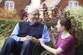 Adult Daughter Visiting Father In Wheelchair