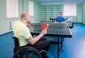 Adult disabled men in a wheelchair playing table tennis Royalty Free Stock Photo