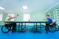 Adult disabled men in a wheelchair playing table tennis Royalty Free Stock Photo