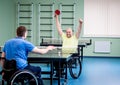 Adult disabled men in a wheelchair playing table tennis Royalty Free Stock Photo