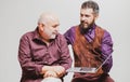 Adult education. Happy young man with senior dad have fun watching funny video on laptop, smiling elderly father and Royalty Free Stock Photo