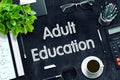 Adult Education - Text on Black Chalkboard. 3D Rendering.