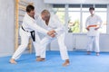 Adult and elderly men training judo fight Royalty Free Stock Photo