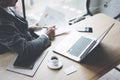 Adult elegant banking finance analyst working at sunny office on laptop while sitting at wooden table.Businessman Royalty Free Stock Photo