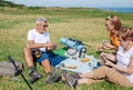 Adult family having a picnic and playing cards during an excursion Royalty Free Stock Photo