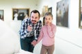 Adult father and daughter exploring statues