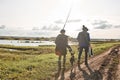 Adult father and teenager son going to fishing together. Royalty Free Stock Photo