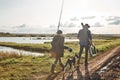 Adult father and teenager son going to fishing together. Royalty Free Stock Photo