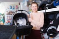 Adult female with car cradle for infant Royalty Free Stock Photo