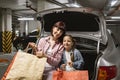 Adult female and child holding colorful bags with clothes from shopping mall. Royalty Free Stock Photo