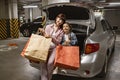 Adult female and child holding colorful bags with clothes from shopping mall. Royalty Free Stock Photo