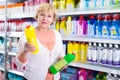 Adult female choosing household chemical goods Royalty Free Stock Photo