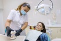 Adult female dentist treating patient woman teeth. Medicine, dentistry and healthcare concept