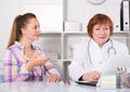 Adult female doctor leading medical appointment Royalty Free Stock Photo