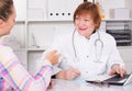 Adult female doctor leading medical appointment Royalty Free Stock Photo