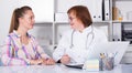 Adult female doctor leading medical appointment Royalty Free Stock Photo