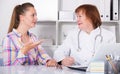 Adult female doctor leading medical appointment Royalty Free Stock Photo