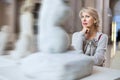 Adult female looking at artwork sculpture in the museum indoors