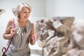 Adult female looking at artwork sculpture in the museum indoors