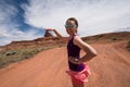 An adult female shows a forced perspective view of Mexican Hat