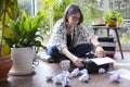 Adult female writer putting new blank sheet of paper on typewriter