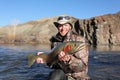 Adult fisherman holding steelhead trout Royalty Free Stock Photo