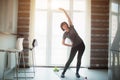 Adult fit slim woman has workout at home. Exercising without equipment and stretching her body. Senior well-built woman Royalty Free Stock Photo