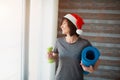 Adult fit slim woman has workout at home. New year or Christmas time period. Well-built adult senior woman resting after