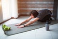 Adult fit slim woman has workout at home. Senior model sitting in asana pose and stretching her body. Strong mature Royalty Free Stock Photo