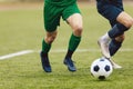 Adult football competition. Soccer football player dribbling a ball and kick a ball during match in the stadium Royalty Free Stock Photo