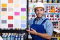 Adult foreman showing samples of paint