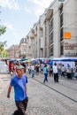 Adult French man walking near Maison Rouge and Ornage store during the Grande