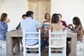 Adult friends sitting together at a dinner party on a patio Royalty Free Stock Photo