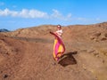 Adult girl posing among the orange-brown empty stone hills in the Sinai desert Royalty Free Stock Photo