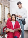 Adult hairdresser working with woman hair in hairdressing salon Royalty Free Stock Photo