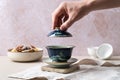 Adult hand grasping a delicate Hand-painted Chinese Gaiwan Royalty Free Stock Photo