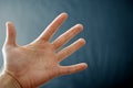 Adult hand with Raynaud`s Syndrome - Phenomenon. Close up hand with fingers on dark background with copy space