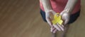 Woman holding yellow ribbon, closeup. cancer awareness concept Royalty Free Stock Photo