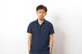 Adult handsome Chinese man wearing blue shirt standing over isolated white background feel depressed Royalty Free Stock Photo