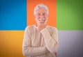 Adult handsome senior man looking at camera smiling standing over colorful cute background. Caucasian 70 years old white-haired Royalty Free Stock Photo