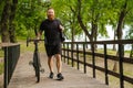 Adult handsome tattooed bearded smiling man i walking with bicycle